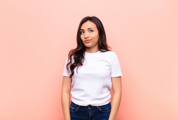 young brunette woman looking puzzled and confused