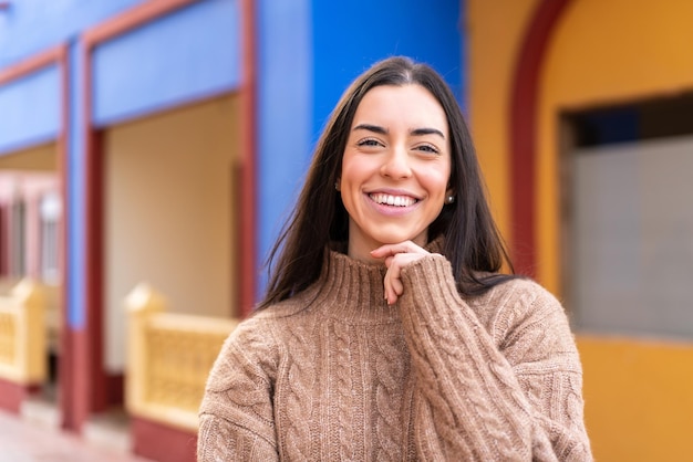 Young brunette woman at outdoors With happy expression