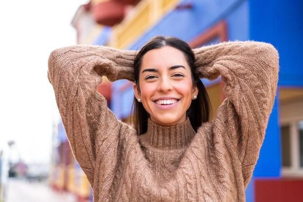 Young brunette woman at outdoors With happy expression