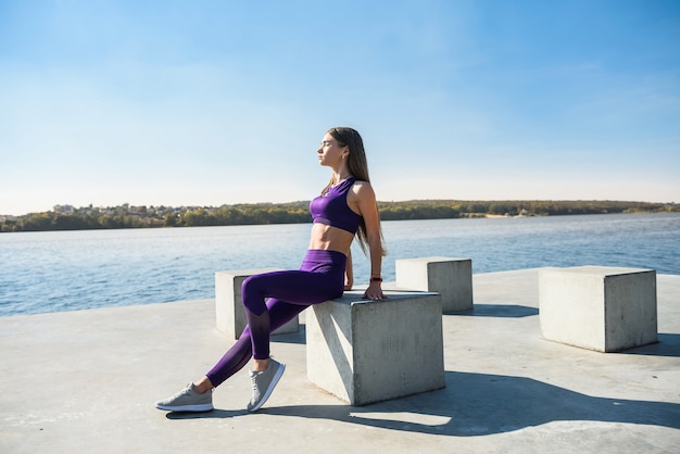 Young brunette woman  practicing yoga early morning before working time.  Concept of wellness and healthy lifestyle