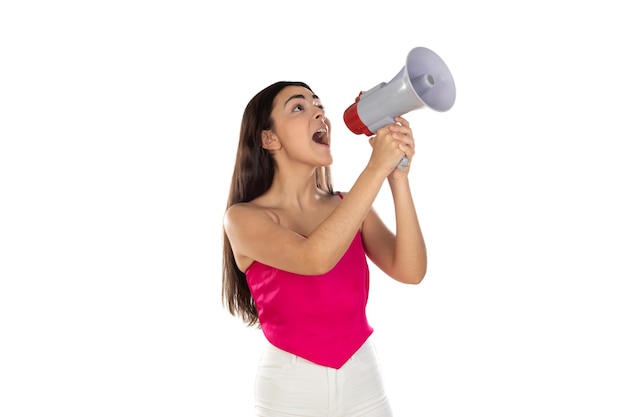 Young brunette woman shouting with a megaphone