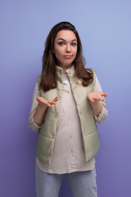 Young brunette woman upset and in doubt over isolated background