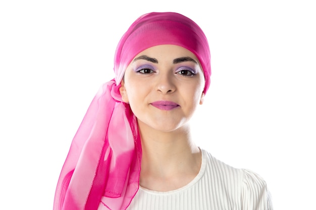 Young brunette woman wearing pink head scarf isolated