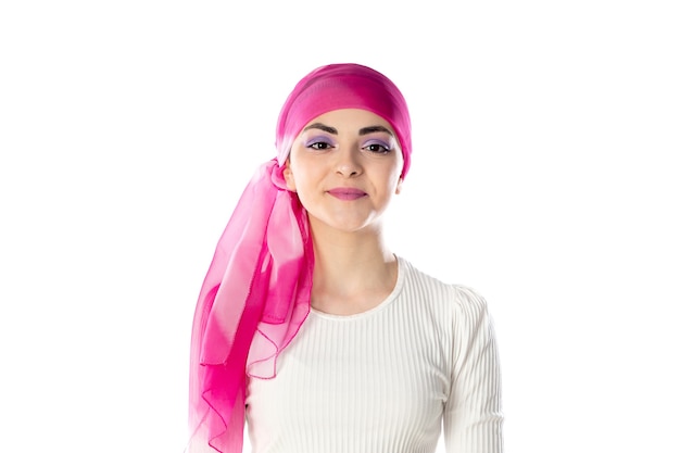 Young brunette woman wearing pink head scarf isolated