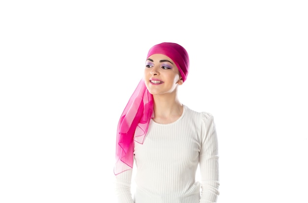 Young brunette woman wearing pink head scarf isolated