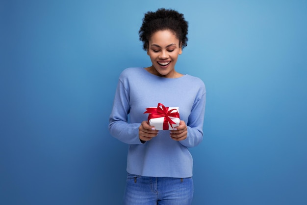 Young brunette woman with afro hair received a birthday present