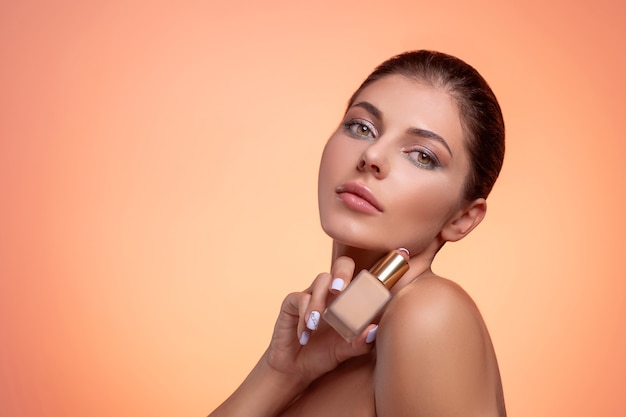 Young brunette woman with foundation