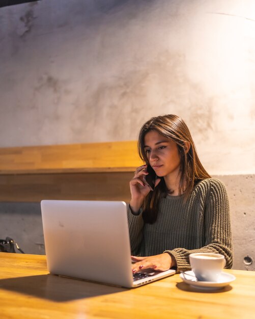 A young brunette woman working in a cafe