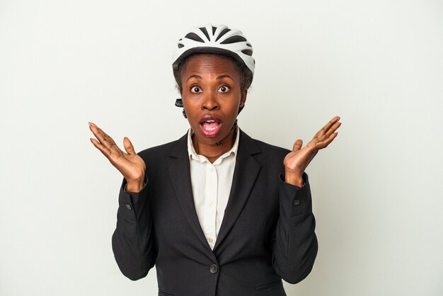 Young business african american woman wearing a bike helmet isolated on white background surprised and shocked.