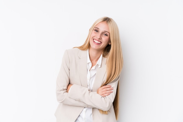 Young business blonde woman on white wall laughing and having fun.