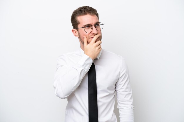 Young business caucasian man isolated on white background having doubts and with confuse face expression