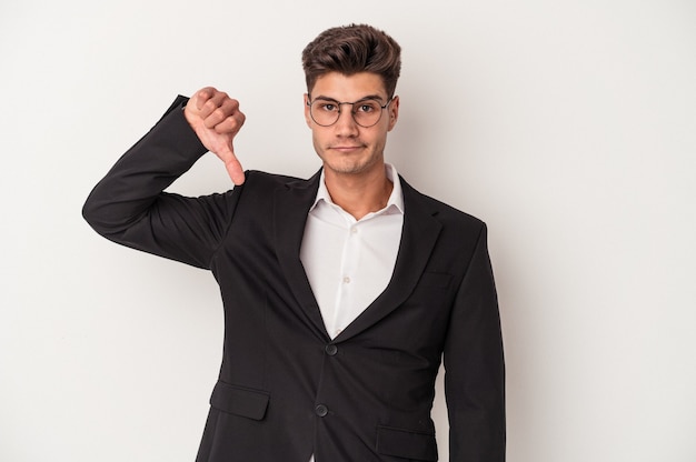 Young business caucasian man isolated on white background showing a dislike gesture, thumbs down. Disagreement concept.