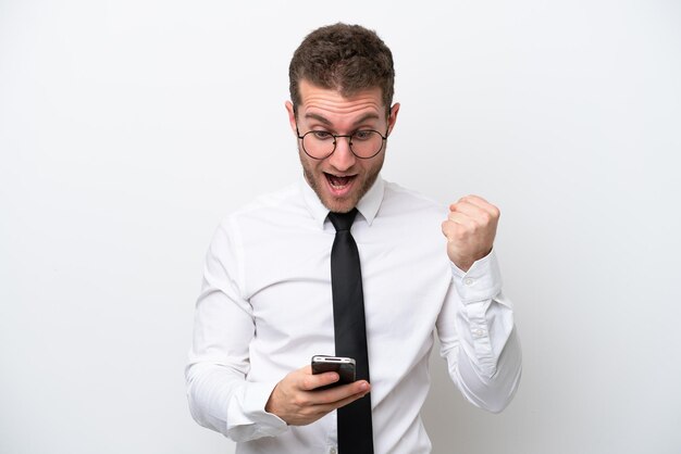 Young business caucasian man isolated on white background surprised and sending a message