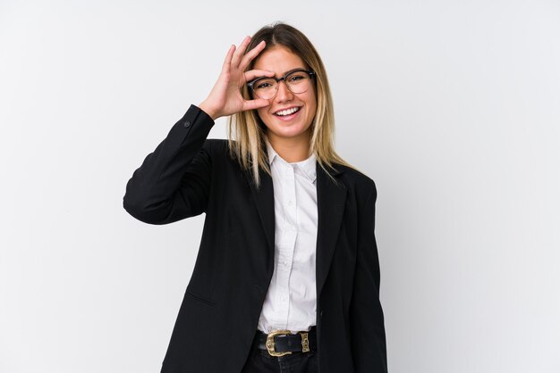 Young business caucasian woman excited keeping ok gesture on eye.