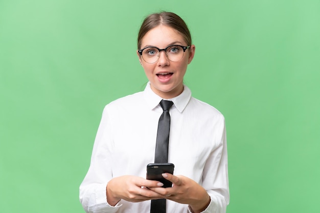 Young business caucasian woman over isolated background surprised and sending a message