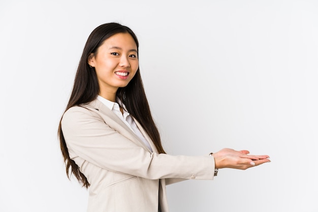 Photo young business chinese woman isolated holding a copy space on a palm.