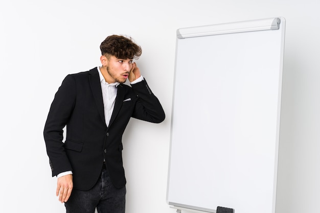 Young business coaching arabian man trying to listening a gossip.