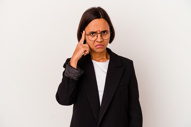 Young business Indian woman isolated on white background pointing temple with finger, thinking, focused on a task.