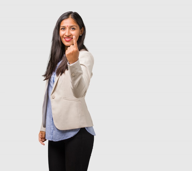 Young business indian woman showing number one, symbol of counting, concept of mathematics, confident and cheerful