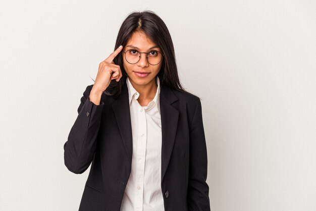 Young business latin woman isolated on white background pointing temple with finger, thinking, focused on a task.