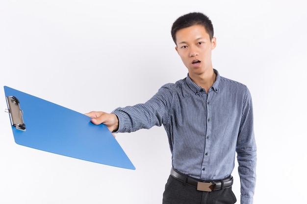 Young business male holding a folder standing in front of white background