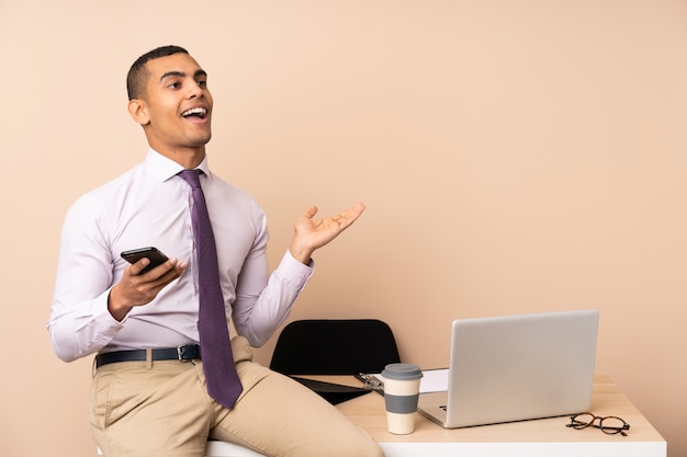 Young business man in a office with surprise facial expression