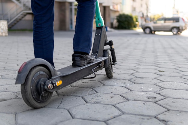 Young business man in a suit riding an electric scooter on business meeting Ecological transportation concept alternative mode of transport