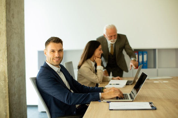 Young business man using laptop computer in the office