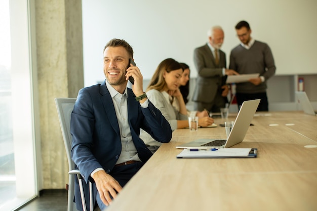 Young business man using mobile phone in the office