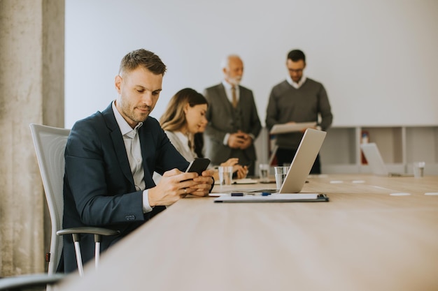 Young business man using mobile phone in the office