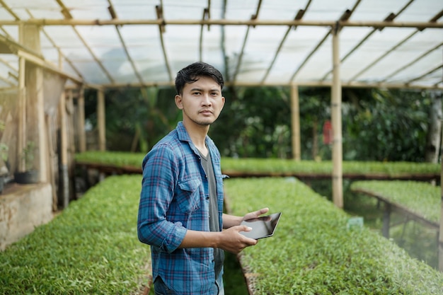 young business man using a tablet checking the farm digital farming photo concept