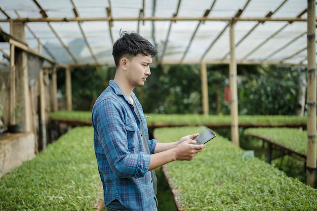 young business man using a tablet checking the farm digital farming photo