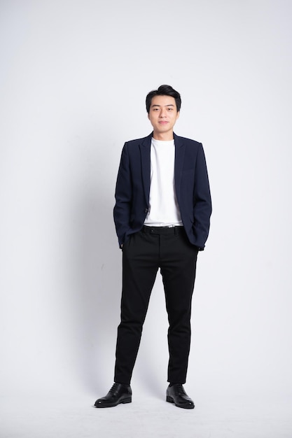 Young business man wearing a suit posing on a white background