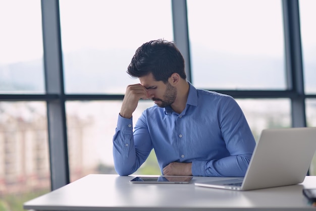 Young business man with problems and stress in the office