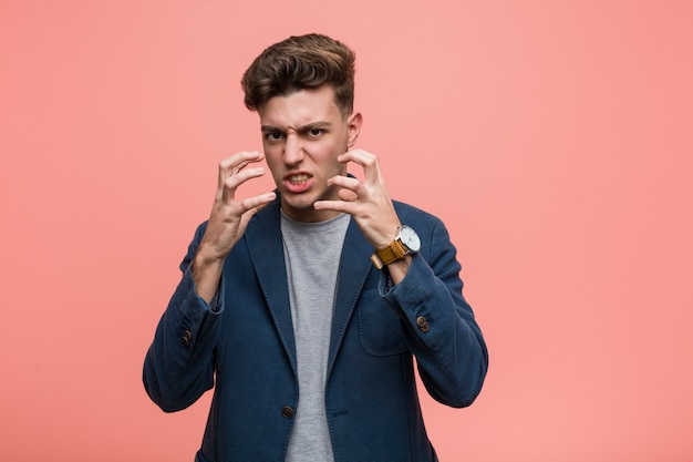 Young business natural man upset screaming with tense hands.