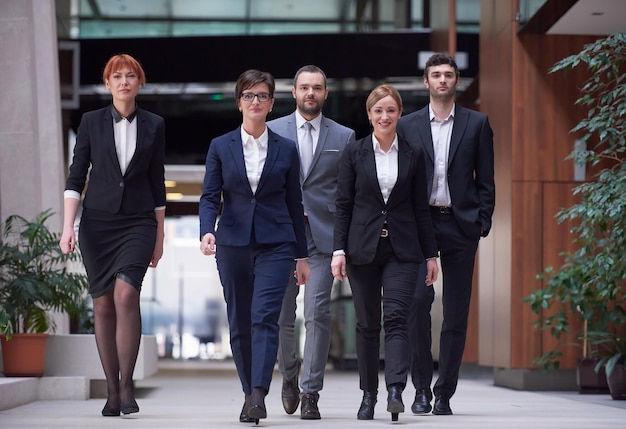 young business people team walking, group of people on modern office hall interior