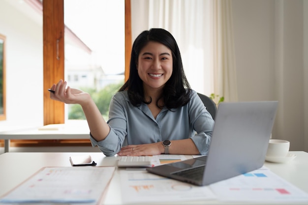 Young business person smiling while analyzing finance budget at corporate Account and audit concept