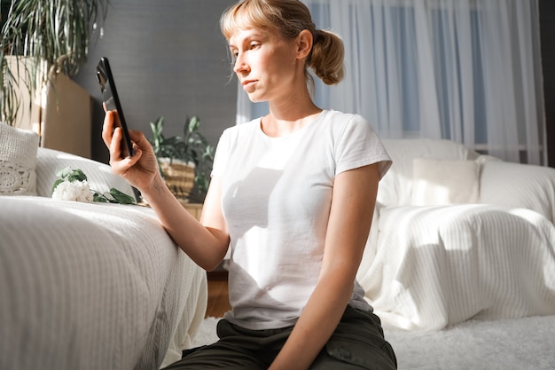 Young business woman communicates on the phone at the computer online. remote communication