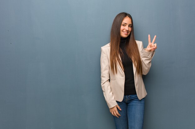 Young business woman doing a gesture of victory