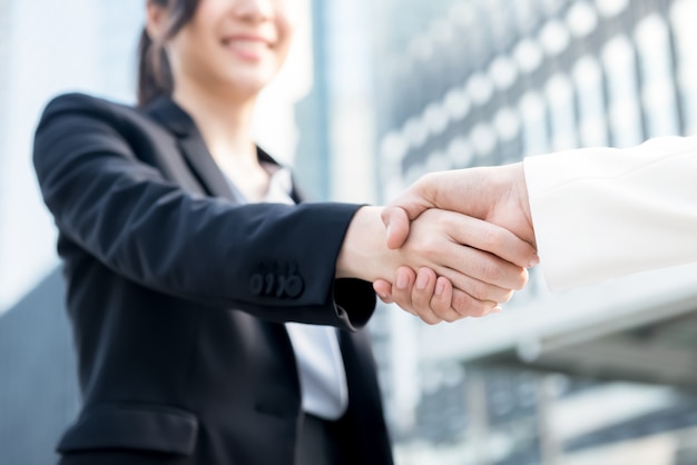 Young business woman leader making handshake with her partner