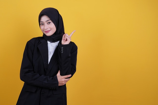 Young business woman pointing up right side on yellow