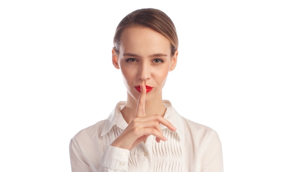 Young business woman showing silence gesture isolated on white background