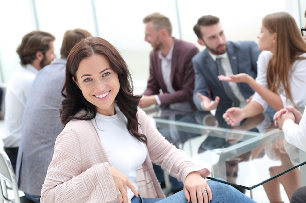 Young business woman sitting at corporate business team meeting