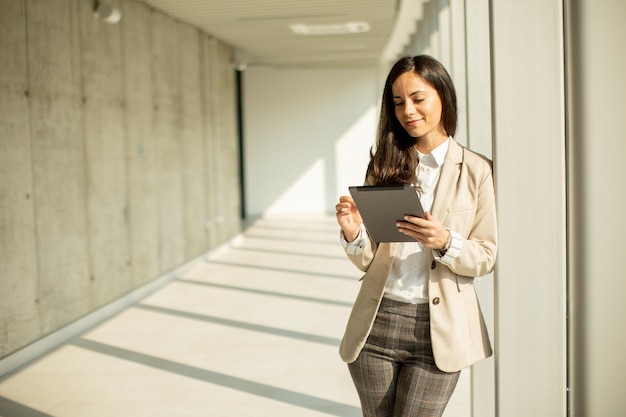 Young business woman at startup office with digital table