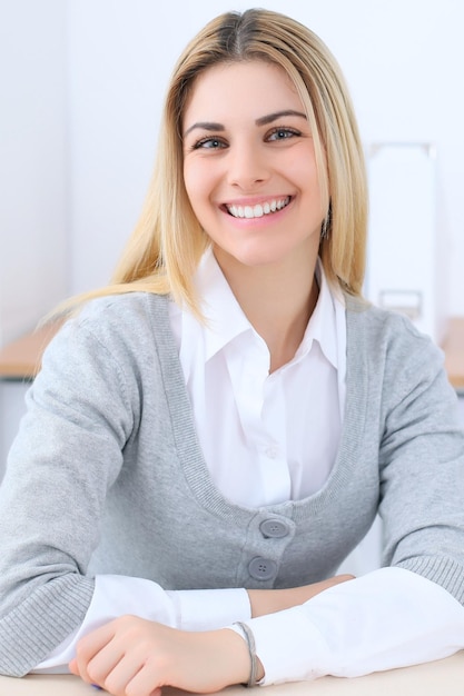 Young business woman or student girl sitting at office workplace with laptop computer. Home business concept.