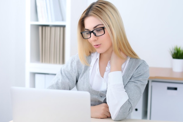 Young business woman or student girl sitting at office workplace with laptop computer Home business concept