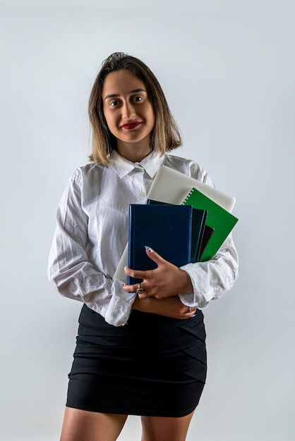 Young business woman teacher holding a book isolated on a white background