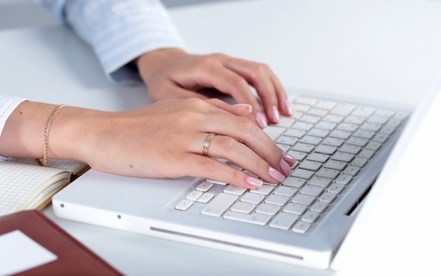 Young business woman with notebook in the office