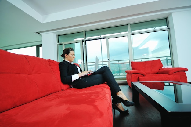 young business woman working on laptop at home in confort bright apartment