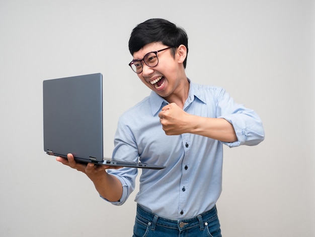 Young businessman angry emotion gesture hit at laptop in hand isolated